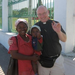 Priest with mother and child