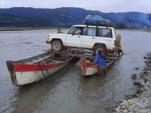 When the rivers are too deep to drive through, alternate and creative ways are found to get trucks and team members across