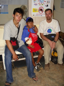 Jeff Solheim (left) with a young boy who came to a clinic with a fractured forearm who received initial treatment (Translator Joey Kittleson on right)