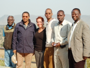 Tracy Maltz standing with the President of Tanzania and his staff