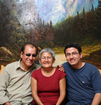 Peruvian artist Victor Mendoza Castillo with his wife and son in front of one of his landscape paintings